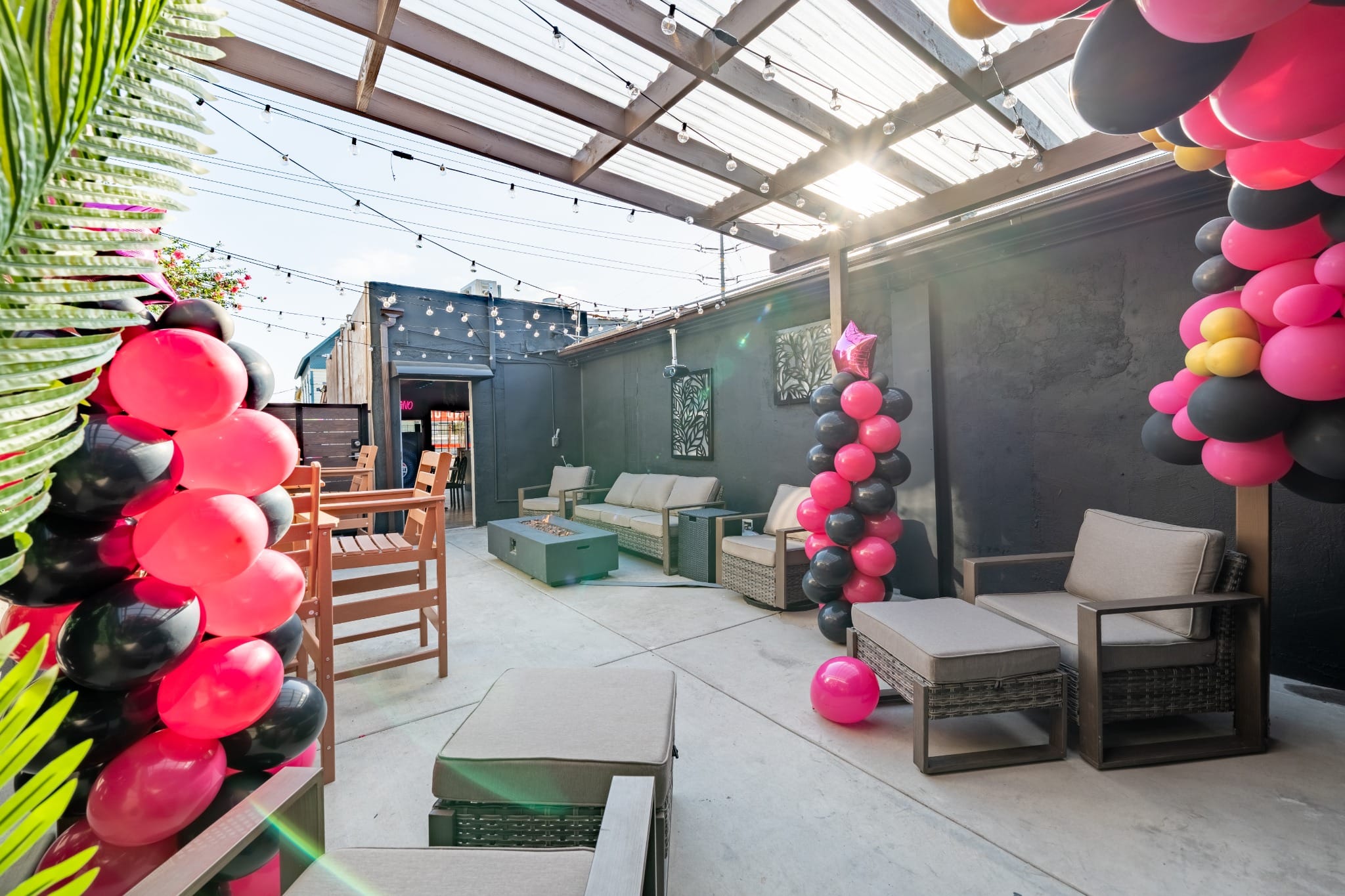 Wide view of the patio with a balloon arch